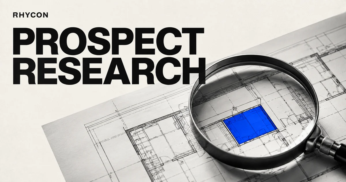 Prospect research: a magnifying glass reveals a blue section of an architectural plan.